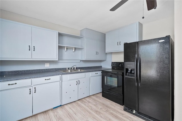 kitchen featuring white cabinets, sink, and black appliances