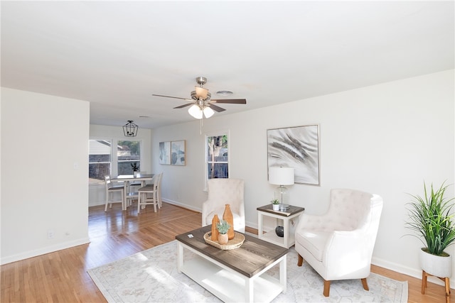 living area with ceiling fan and light hardwood / wood-style floors