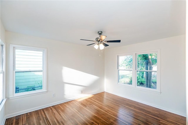 spare room with hardwood / wood-style floors and ceiling fan