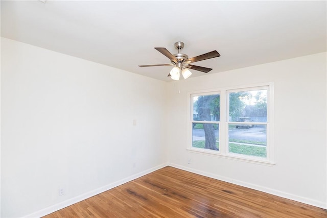 empty room with hardwood / wood-style floors and ceiling fan