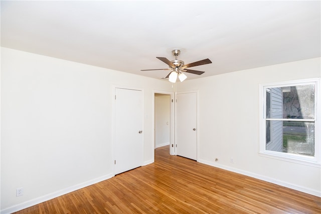 empty room featuring ceiling fan and light hardwood / wood-style floors