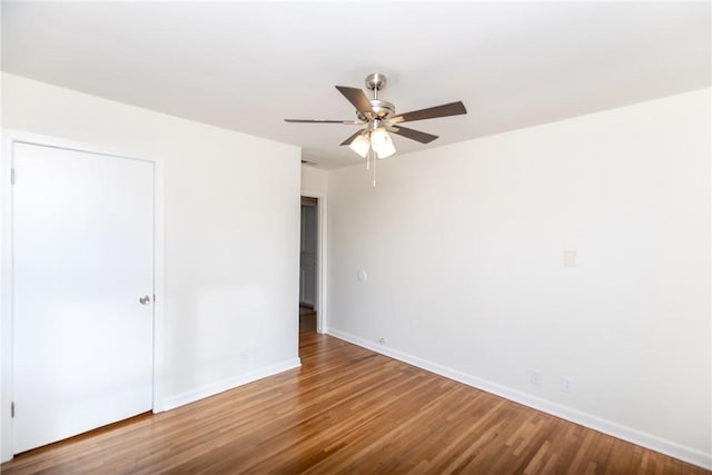 empty room with ceiling fan and wood-type flooring