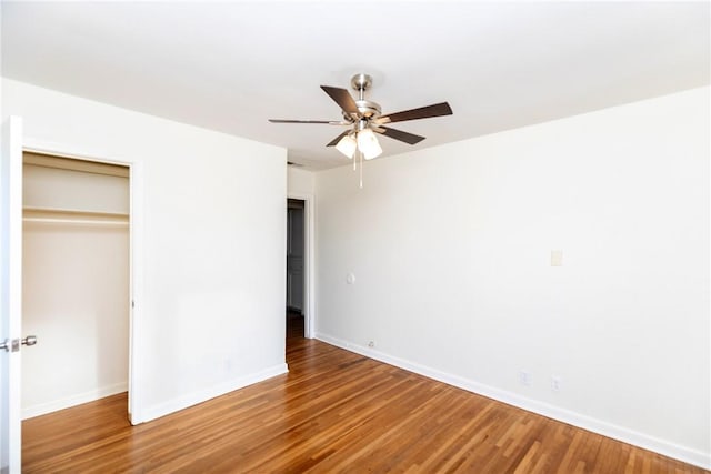 unfurnished bedroom with hardwood / wood-style flooring, ceiling fan, and a closet