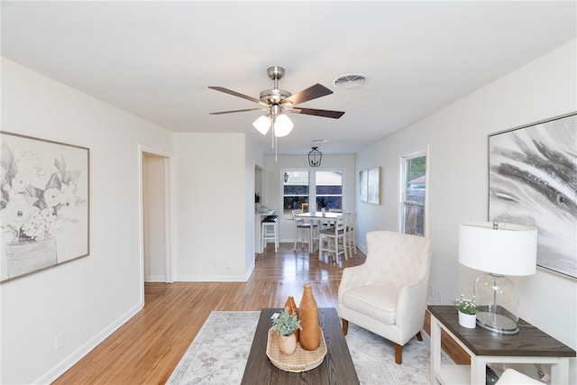 living room featuring ceiling fan and light wood-type flooring