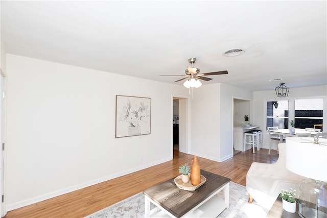 living room featuring hardwood / wood-style flooring and ceiling fan