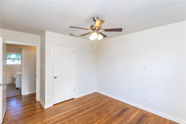 spare room featuring wood-type flooring and ceiling fan