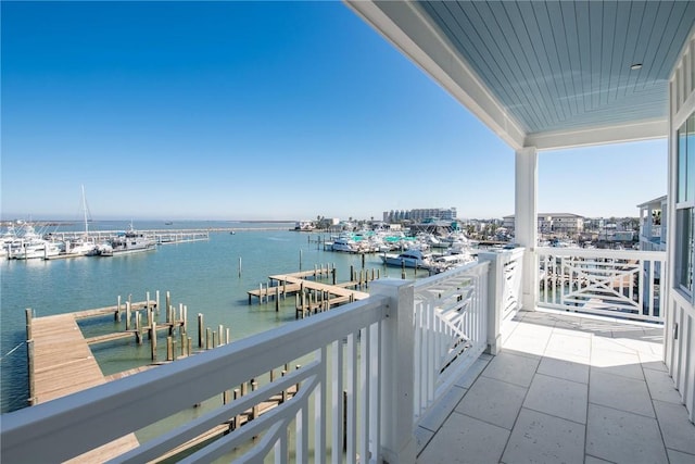 balcony featuring a dock and a water view