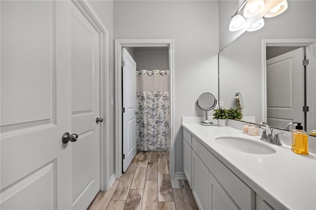 full bathroom with vanity and wood finished floors