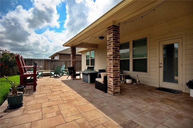 view of patio with fence and an outdoor fire pit