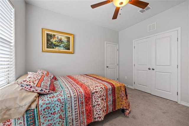 bedroom with visible vents, a ceiling fan, and carpet floors