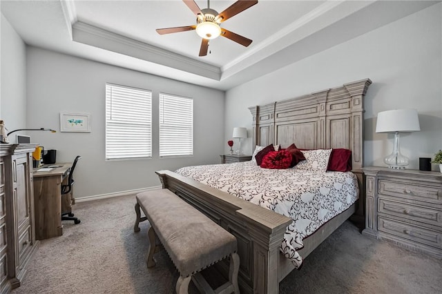 bedroom with light carpet, a raised ceiling, a ceiling fan, baseboards, and ornamental molding