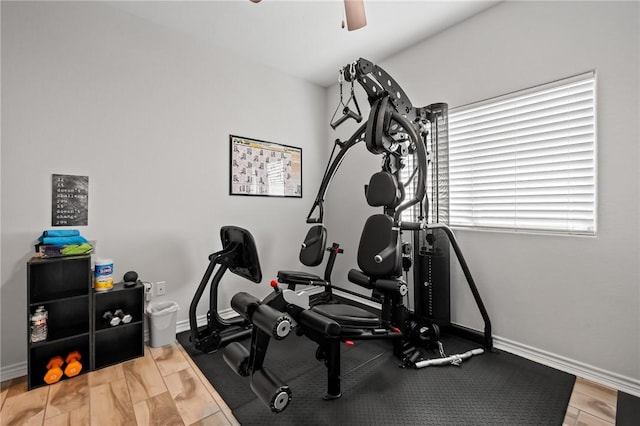 exercise area featuring ceiling fan and baseboards