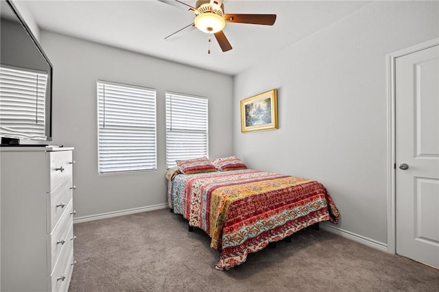 carpeted bedroom featuring baseboards and a ceiling fan