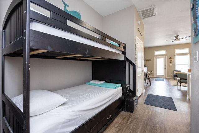 bedroom featuring wood finished floors and visible vents