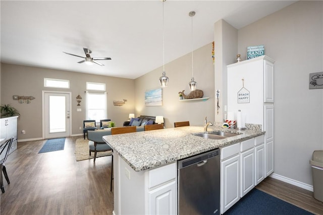 kitchen featuring stainless steel dishwasher, dark wood-type flooring, white cabinetry, a sink, and a peninsula