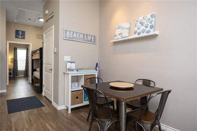 dining space with dark wood-style floors and baseboards