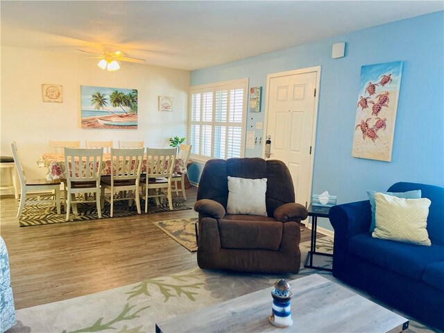 living room featuring ceiling fan and wood-type flooring