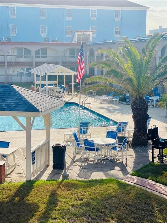 view of swimming pool with a lawn and a patio