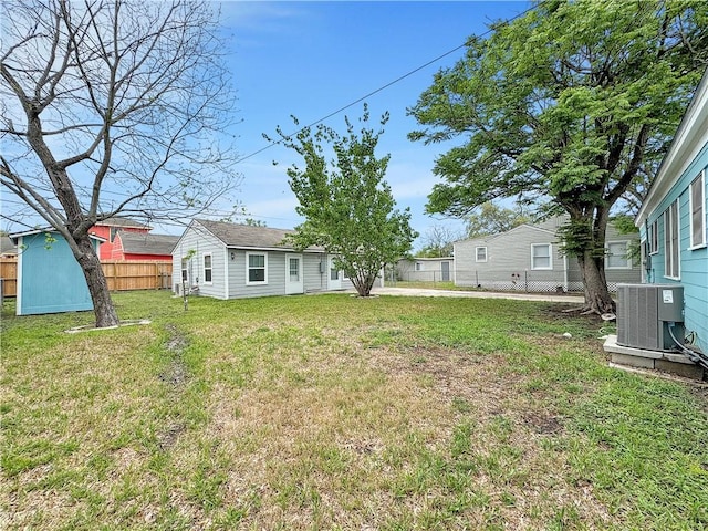 1245 Florida Ave, Corpus Christi, TX 78404 - view of yard with a fenced backyard, an outbuilding, and central AC unit