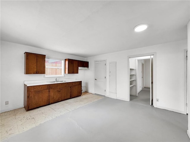 1245 Florida Ave, Corpus Christi, TX 78404 - kitchen with baseboards, light countertops, concrete floors, and a sink