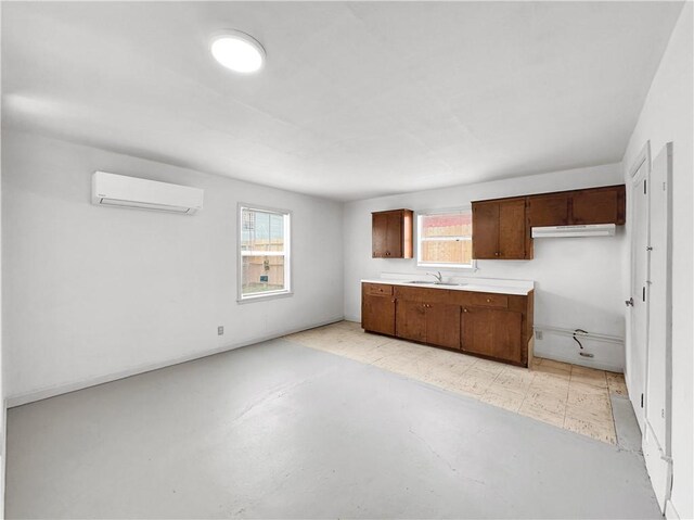 1245 Florida Ave, Corpus Christi, TX 78404 - kitchen with light countertops, light floors, an AC wall unit, and a sink