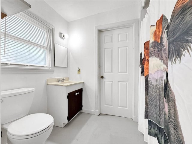 1245 Florida Ave, Corpus Christi, TX 78404 - bathroom with concrete flooring, toilet, vanity, and baseboards