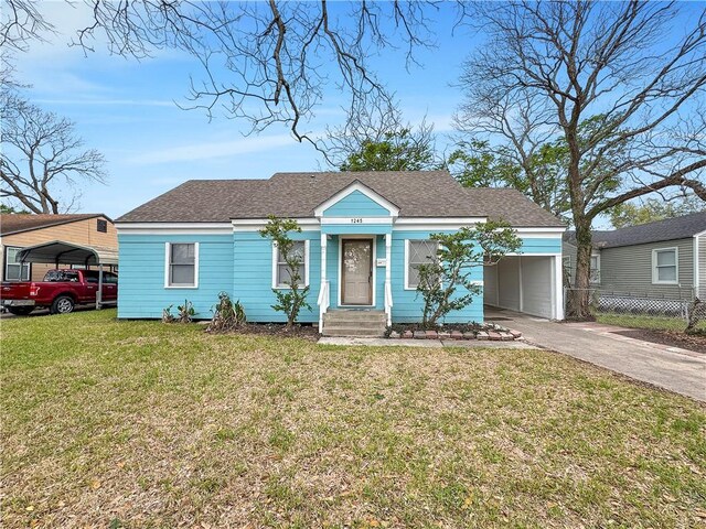 1245 Florida Ave, Corpus Christi, TX 78404 - view of front facade featuring a front lawn, concrete driveway, and roof with shingles