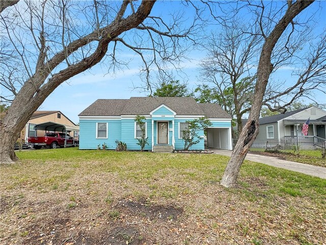 1245 Florida Ave, Corpus Christi, TX 78404 - view of front of house with driveway, a front yard, and a carport