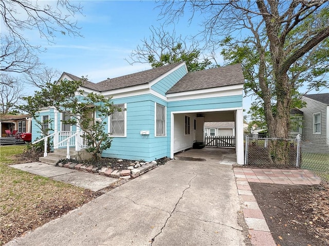 1245 Florida Ave, Corpus Christi, TX 78404 - bungalow-style house with roof with shingles, a carport, fence, and concrete driveway
