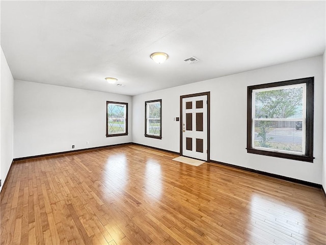 1245 Florida Ave, Corpus Christi, TX 78404 - empty room featuring baseboards, visible vents, and light wood-style floors