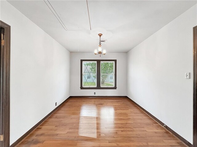 1245 Florida Ave, Corpus Christi, TX 78404 - unfurnished room featuring visible vents, baseboards, a chandelier, and light wood-type flooring