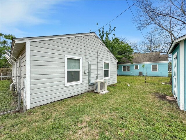 1245 Florida Ave, Corpus Christi, TX 78404 - rear view of house featuring ac unit, fence, and a lawn