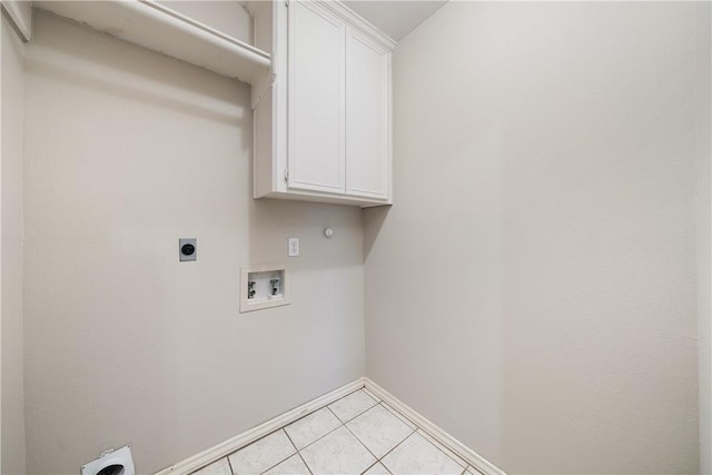 laundry area featuring light tile patterned floors, hookup for a washing machine, cabinets, and electric dryer hookup