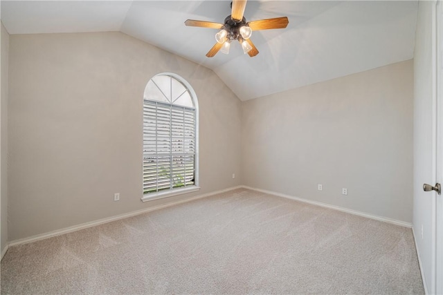 carpeted spare room with ceiling fan and lofted ceiling