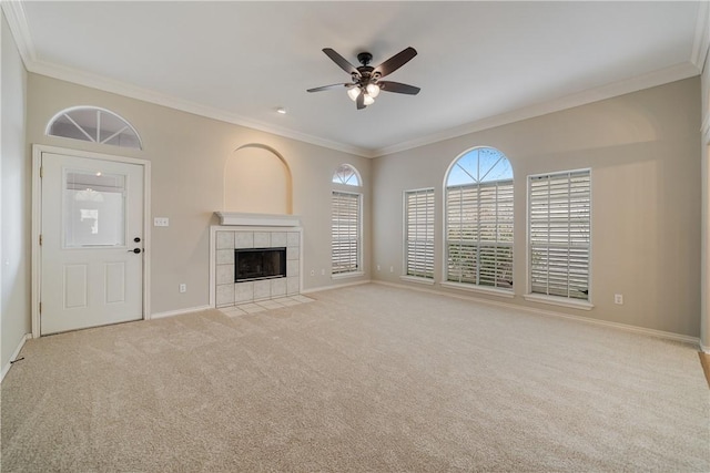 unfurnished living room with ceiling fan, light carpet, a tile fireplace, and crown molding