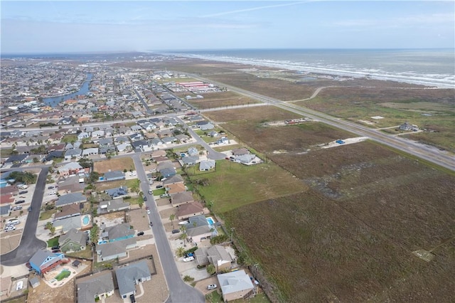 bird's eye view featuring a water view and a view of the beach