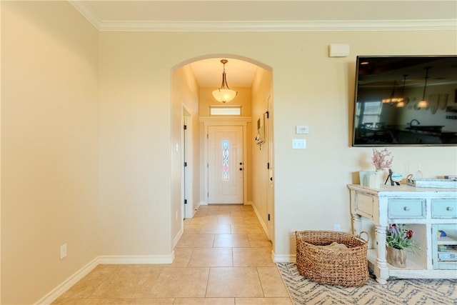 foyer entrance featuring light tile patterned floors and crown molding