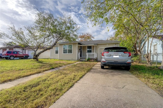 single story home featuring a front lawn and a garage