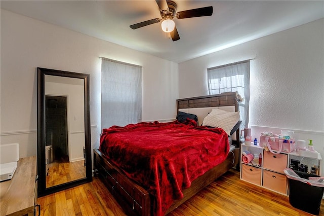 bedroom with ceiling fan and light hardwood / wood-style floors