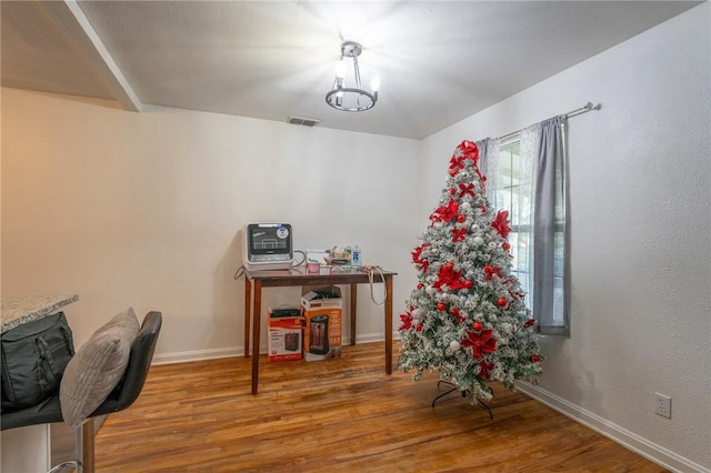 home office with hardwood / wood-style floors