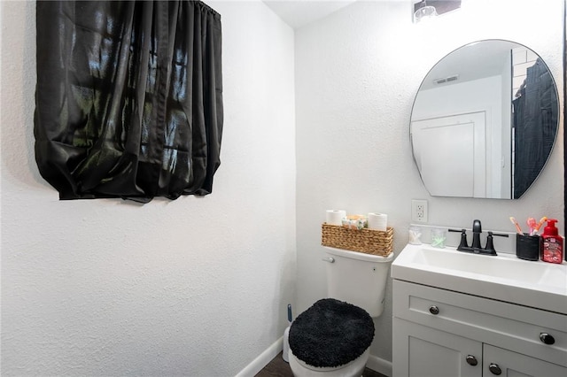 bathroom featuring toilet and vanity