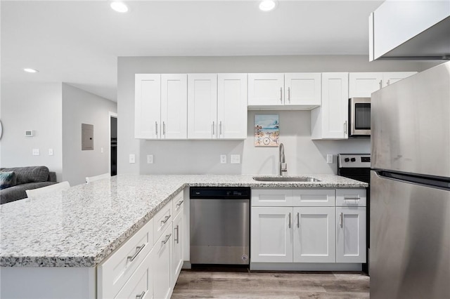 1107 E 11th St Unit H58, Port Aransas, TX 78373 - kitchen with recessed lighting, white cabinetry, stainless steel appliances, and a sink