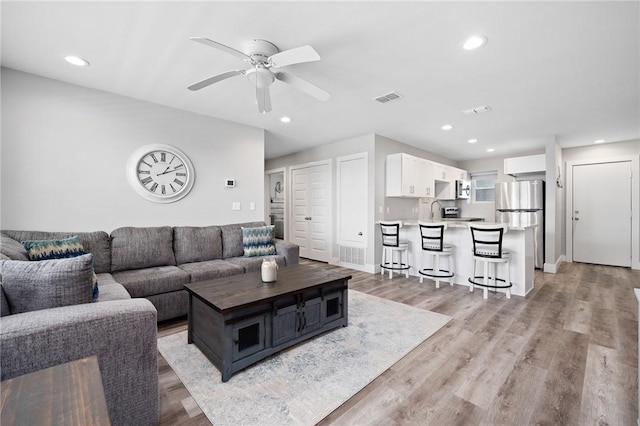 1107 E 11th St Unit H58, Port Aransas, TX 78373 - living room with a ceiling fan, light wood-style floors, and recessed lighting