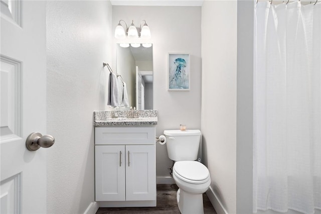 1107 E 11th St Unit H58, Port Aransas, TX 78373 - full bath with wood finished floors, baseboards, vanity, and toilet