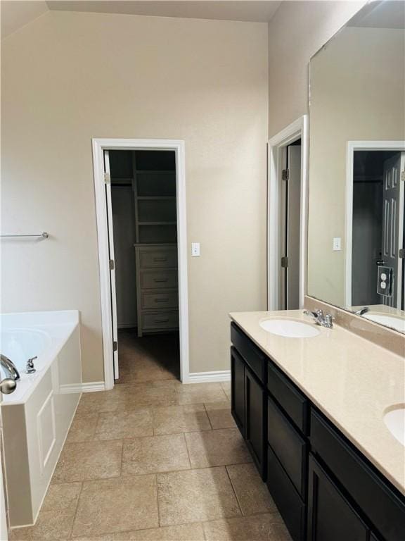 7209 Lands End Dr, Corpus Christi, TX 78414 - full bathroom with double vanity, a garden tub, lofted ceiling, and stone finish flooring