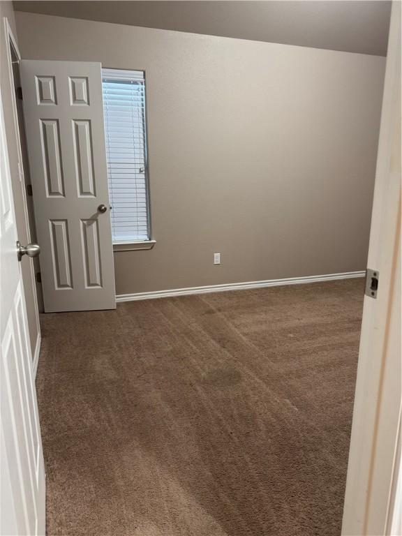 7209 Lands End Dr, Corpus Christi, TX 78414 - spare room featuring dark colored carpet and baseboards