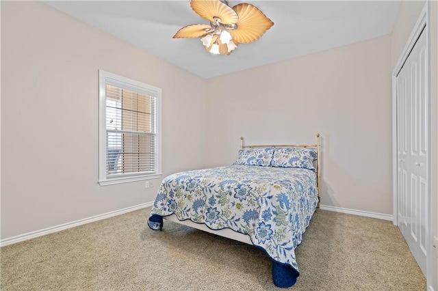 bedroom with a closet, carpet flooring, and baseboards