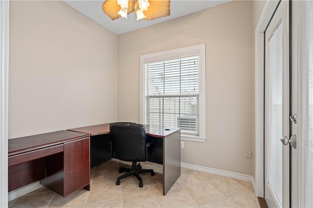 home office with light tile patterned floors, baseboards, and a ceiling fan