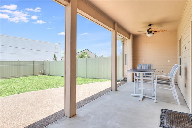 view of patio with ceiling fan, outdoor dining space, and a fenced backyard