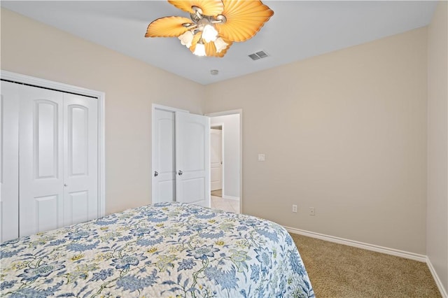 carpeted bedroom with visible vents, a closet, a ceiling fan, and baseboards